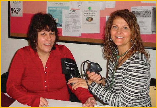 Sonja Stendal meets with a guest to provide blood pressure screening at the KentHOPE Day Center