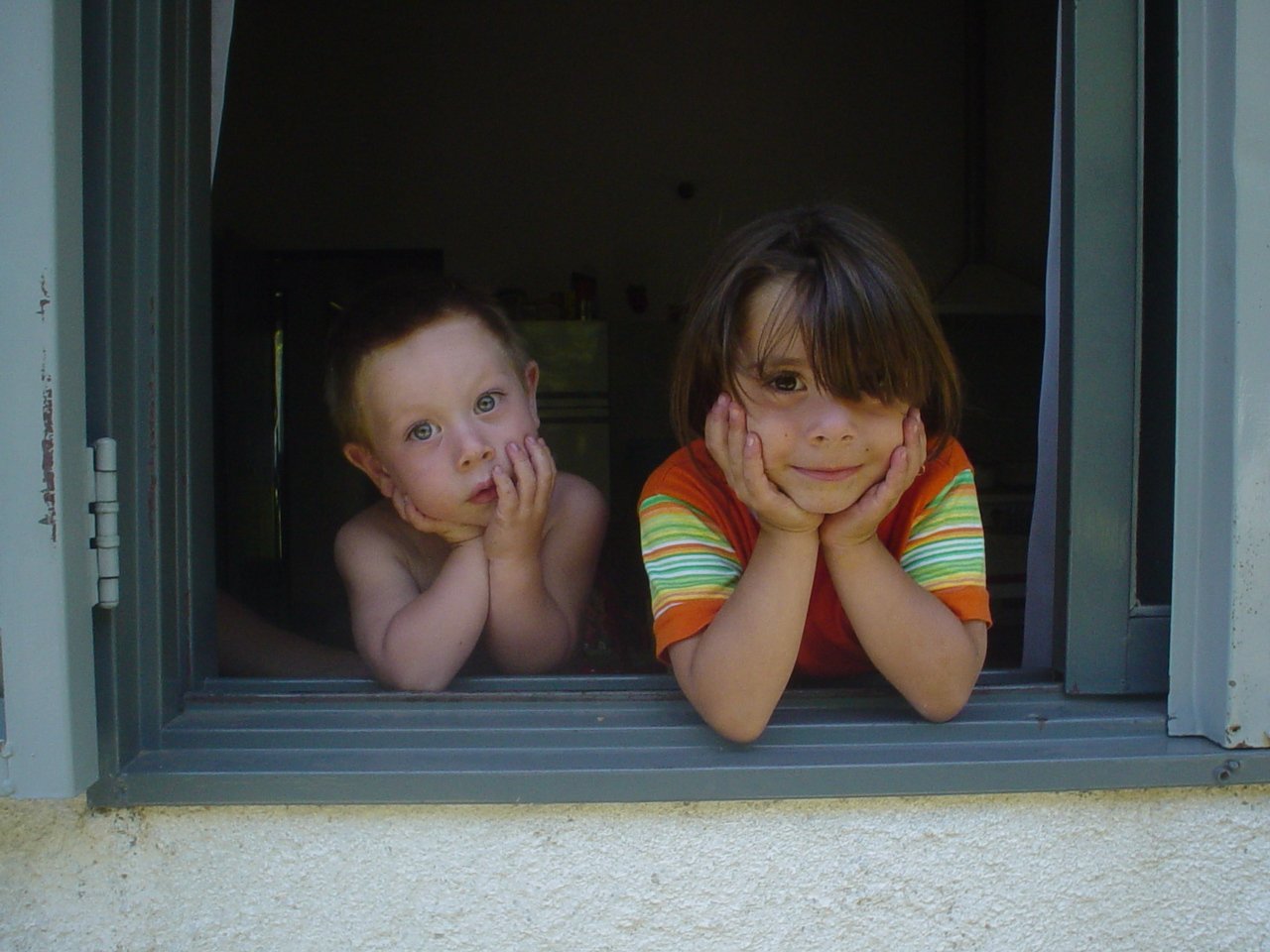 Two kids looking out open window. Photo by Mario Rassi: https://bit.ly/2WA1aIz