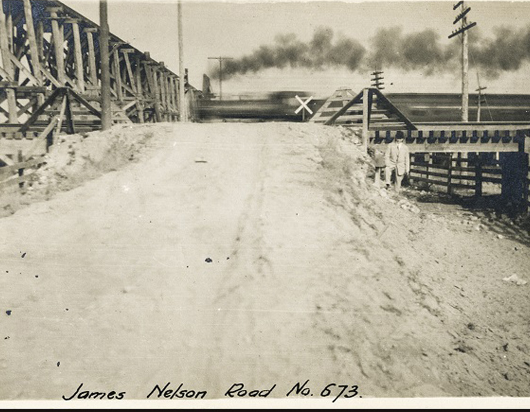 Dirt road with a wooden trestle on the left