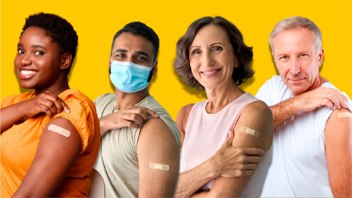 group of people with one person masked and all indicating COVID vaccination
