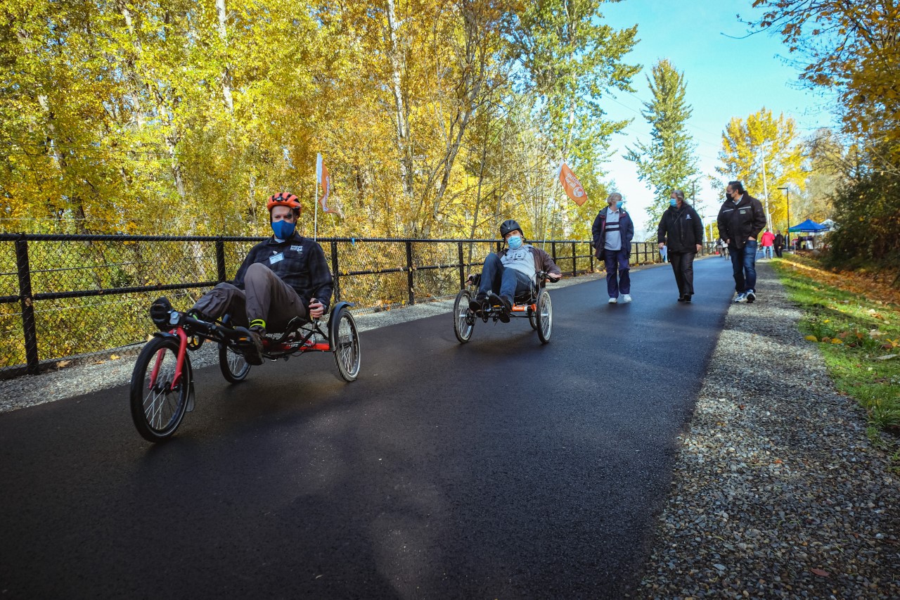 Recumbent cyclists and walkers using the new section of the Eastrail Trail. 