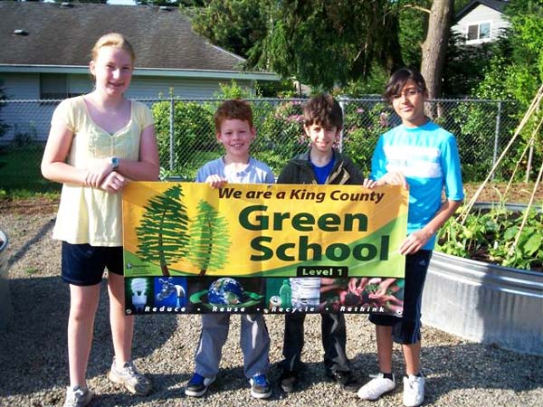 Sherwood Forest students with their "we are green" school banner