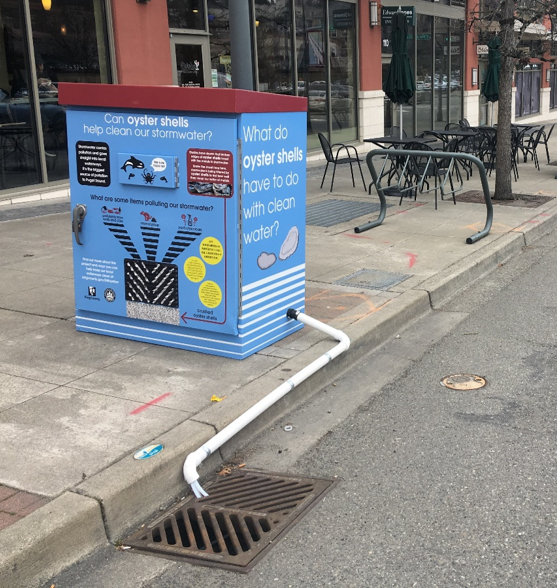 Sampling equipment at a retrofitted catch basin in Mercer Island Town Center with interpretive signage