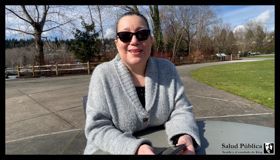 Woman sitting in a park wearing sunglasses