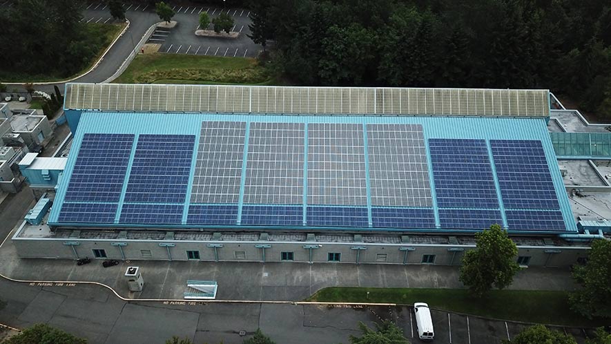 An aerial photo of solar panels on the King County Aquatic Center roof.