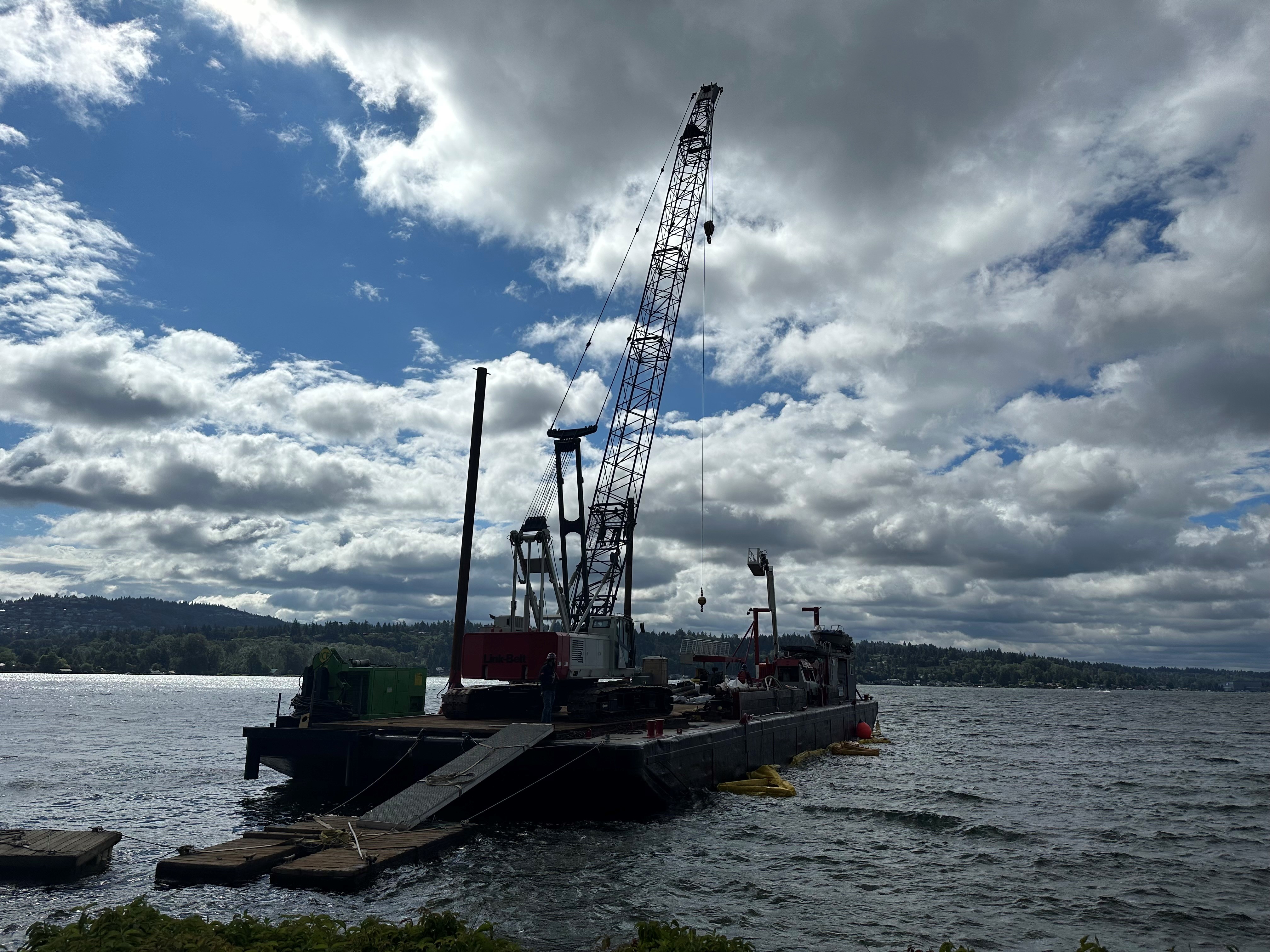 Barge on lake with creosote-treated pilings