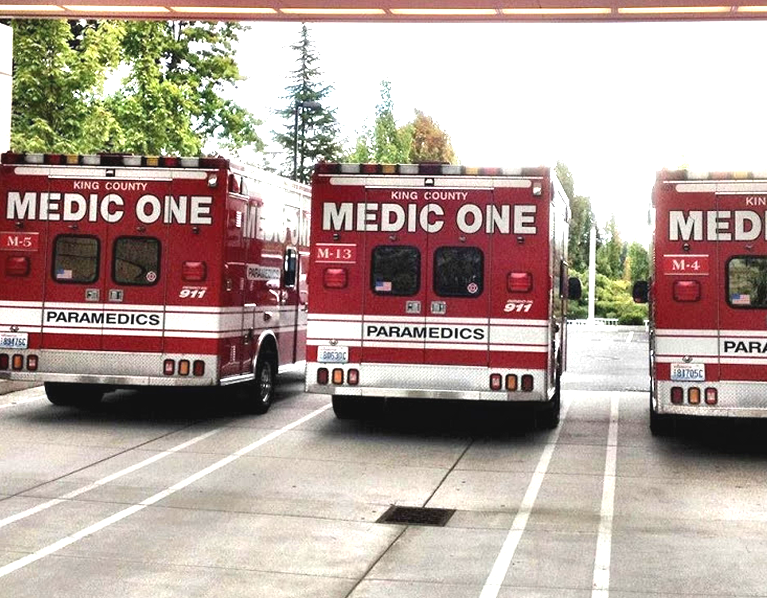 Three Medic One trucks parked