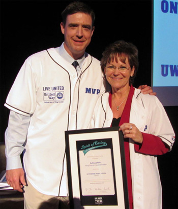 Image: Councilmember Lambert receives her award from former Mariners catcher Dan Wilson, who co-chaired United Way’s 2012-13 Annual Giving Campaign. 