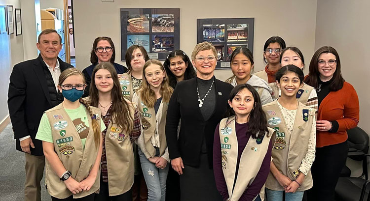 Councilmembers von Reichbauer and Perry post with a group of girl scouts.