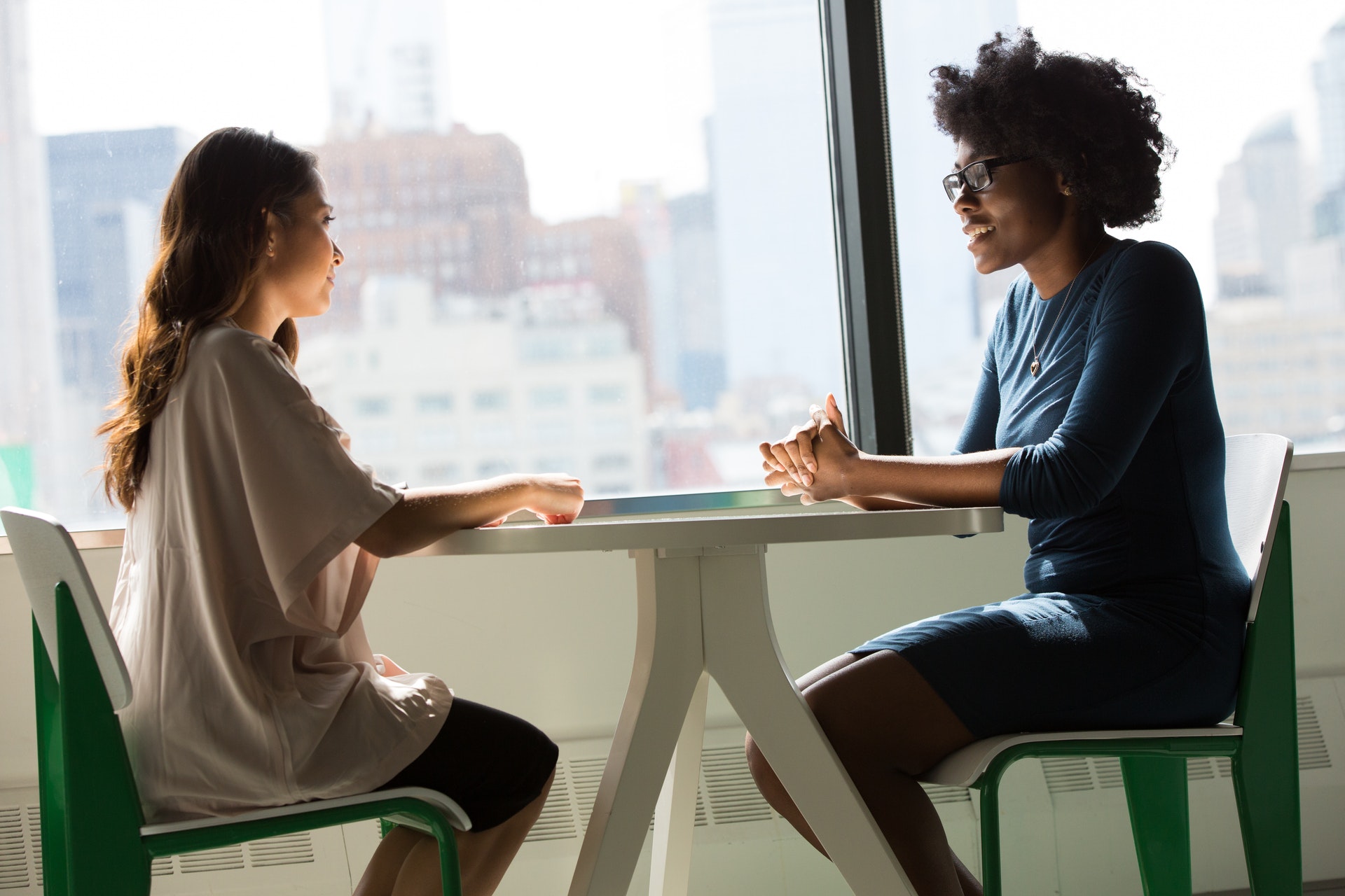 two women sitting on chairs