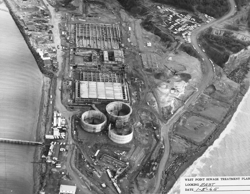 Aerial view of the plant under construction looking west, January 5, 1965