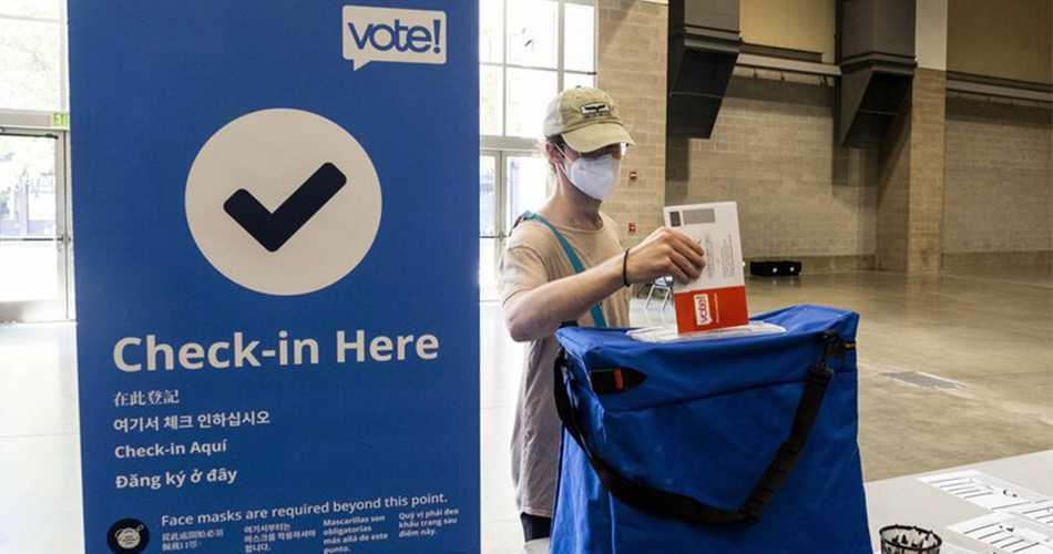 Voter returning ballot at vote center