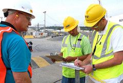 Three inspectors review plans at the Savannah River Site.
