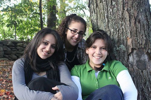 Three teen-age girls sitting by a tree byKars4Kids