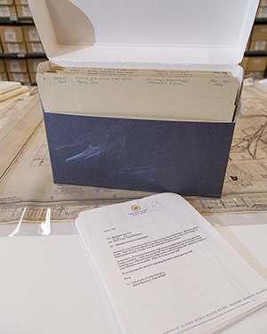Grey records box with the lid flipped up to reveal folders