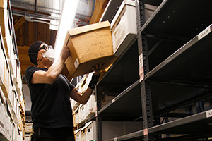 Man putting a box on a shelf