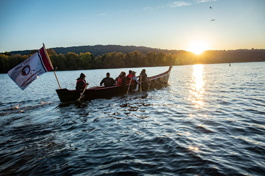 A canoe paddles into Lake Washington.