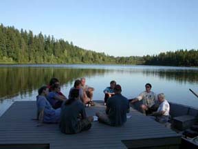 Community members meet on a Spring Lake dock to discuss plans to control milfoil.