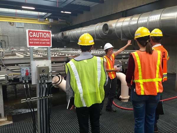 group of adults at a treatment plant tour